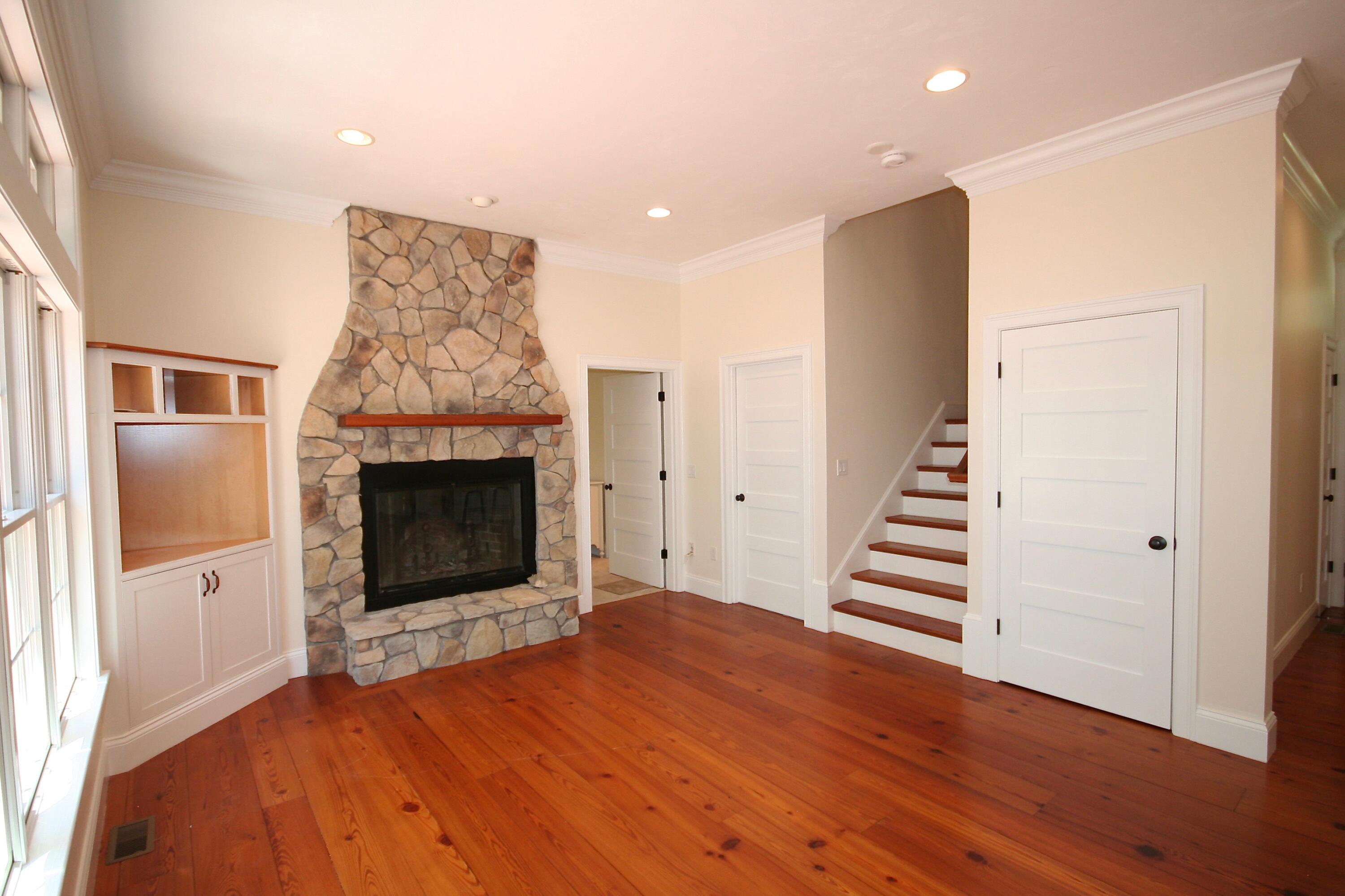 5 Point Road Mashpee, MA 02649 - Photo 17 of 29 a view of a livingroom with wooden floor and a fireplace