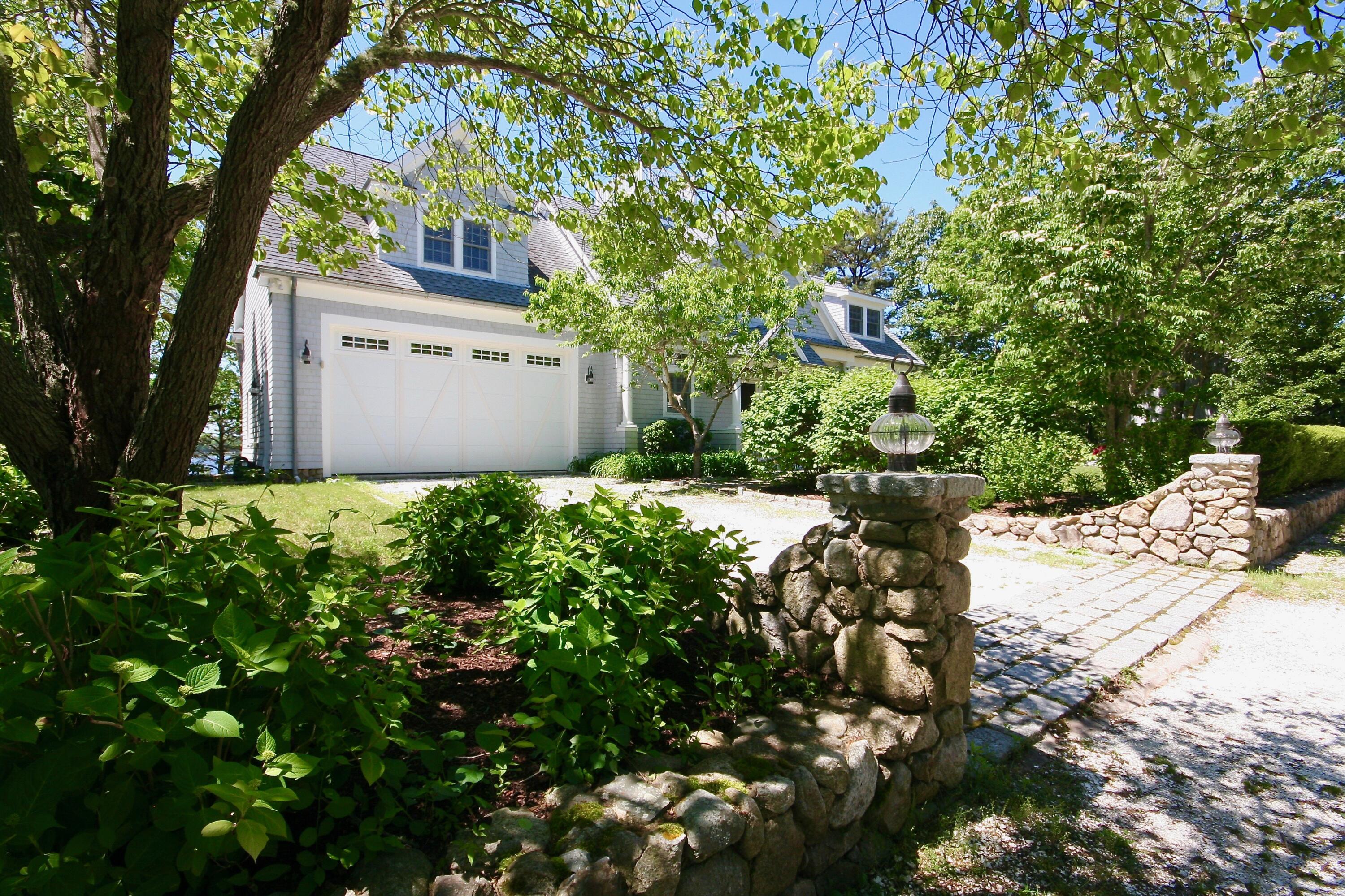 5 Point Road Mashpee, MA 02649 - Photo 3 of 29 a garden covered with tall trees
