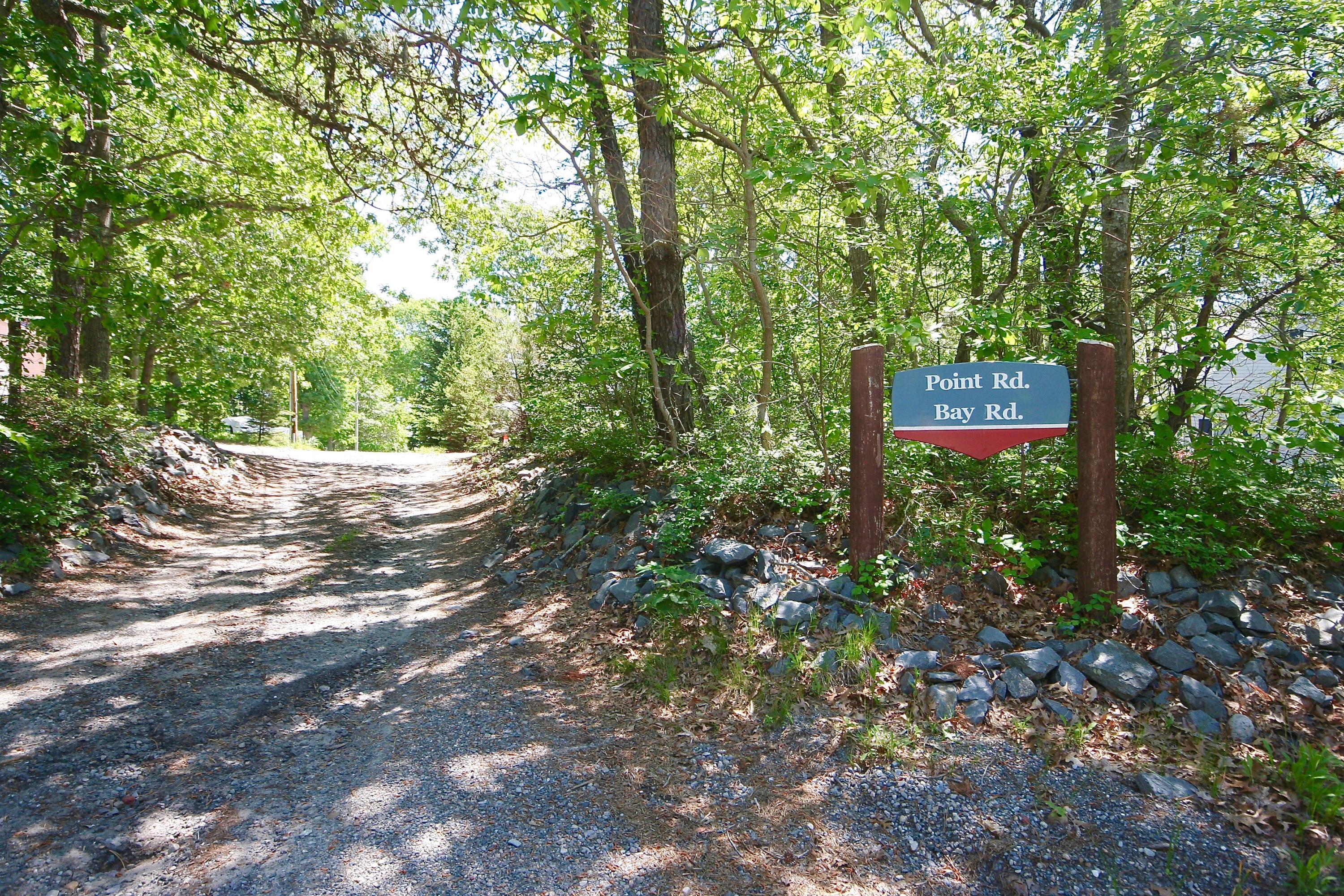 5 Point Road Mashpee, MA 02649 - Photo 5 of 29 a sign that is sitting in a forest