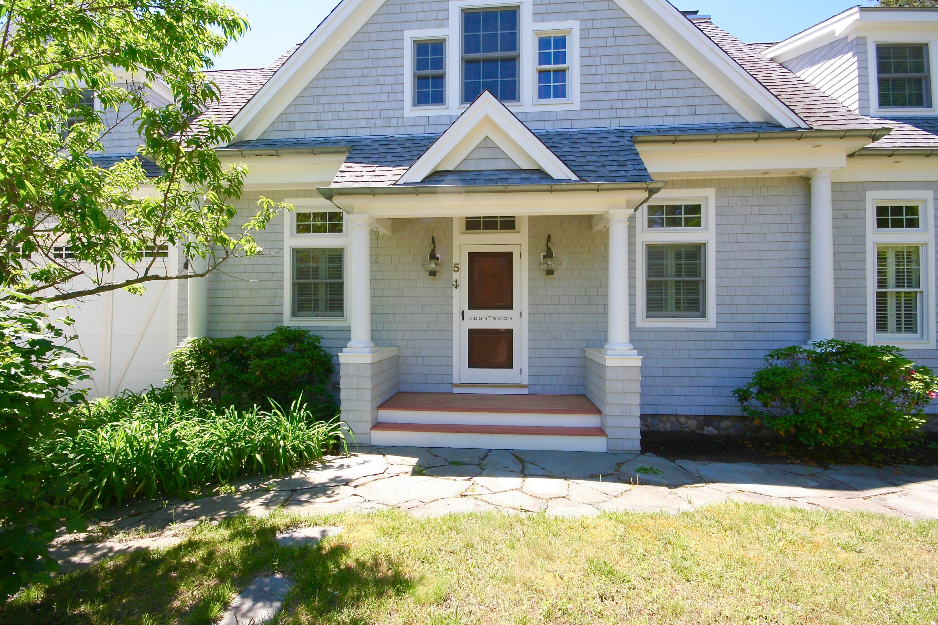 5 Point Road Mashpee, MA 02649 - Photo 10 of 29 a front view of a house with a yard