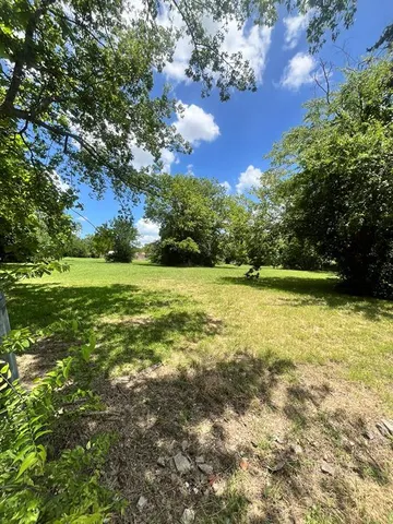a view of a field with an trees