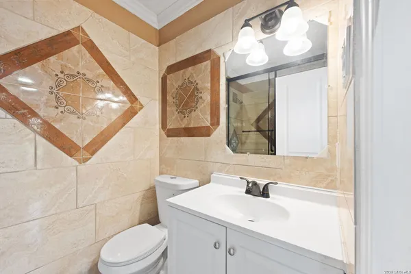 a bathroom with a sink a toilet and mirror