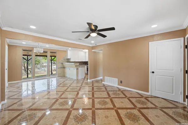 a view of a livingroom with furniture a ceiling fan and window
