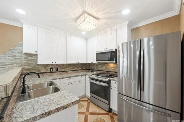 a kitchen with a sink stove and refrigerator