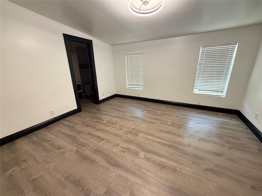222 Hix Road Cleburne, TX 76031 - Photo 10 of 27 an empty room with wooden floor and window