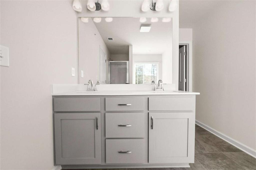 1328 Riverstone Road Jonesboro, GA 30238 - Photo 14 of 26 a bathroom with a sink vanity and a mirror