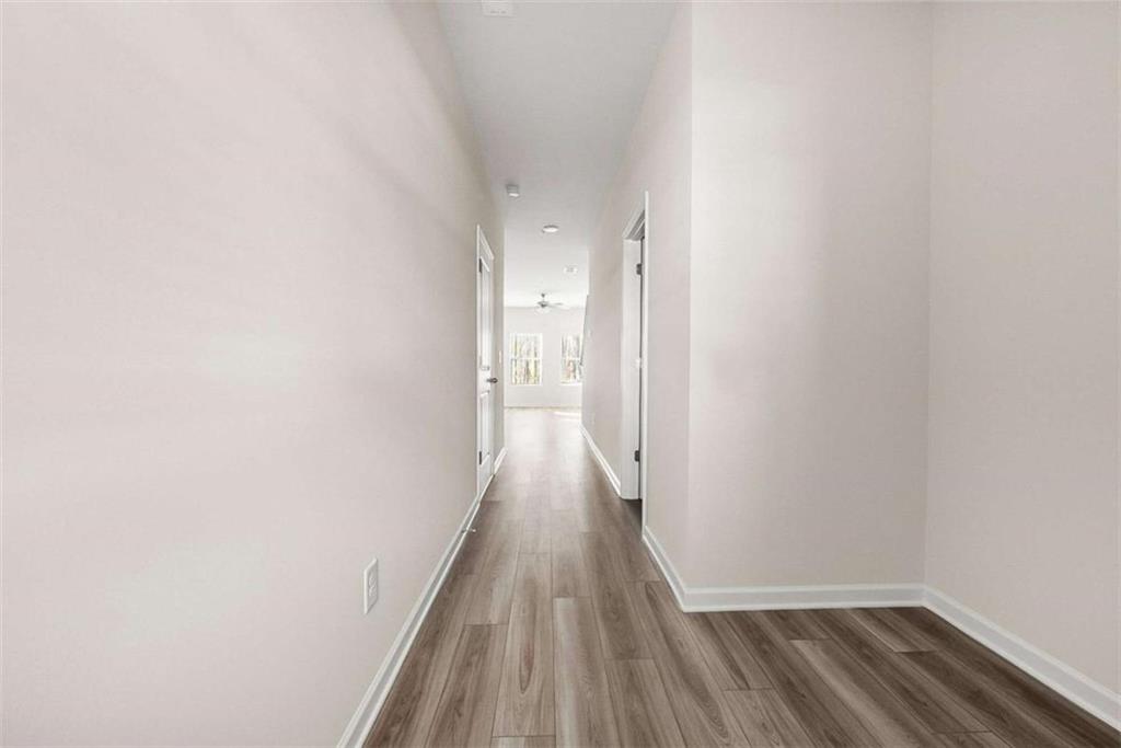 1328 Riverstone Road Jonesboro, GA 30238 - Photo 3 of 26 a view of a hallway with wooden floor