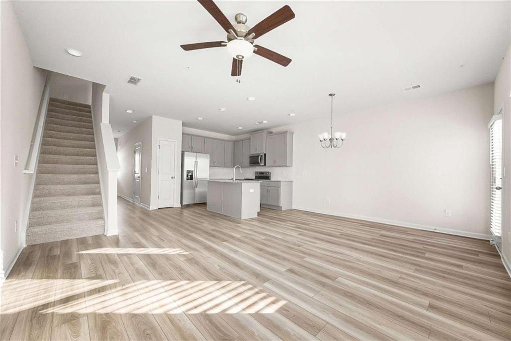 1328 Riverstone Road Jonesboro, GA 30238 - Photo 10 of 26 a view of kitchen and empty room with wooden floor