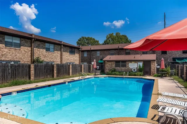 a view of a house with a small yard and floor to ceiling window