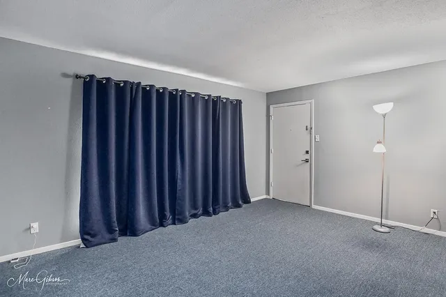 a view of an empty room with wooden walls