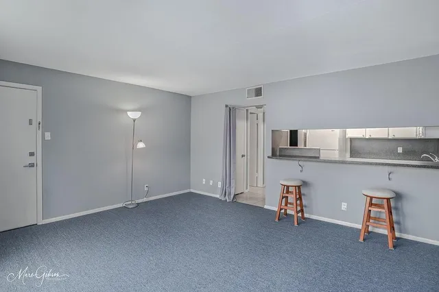 a view of kitchen with refrigerator cabinets and wooden floor