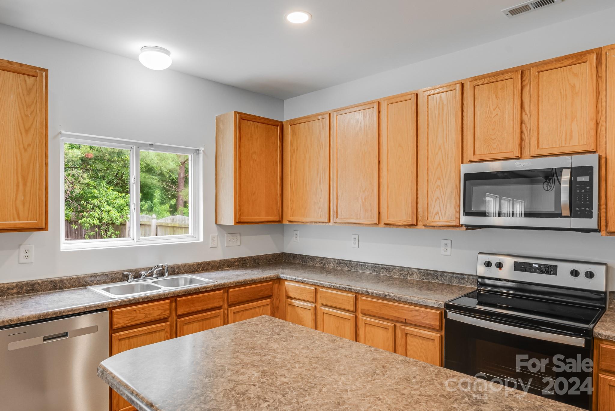 4420 Red Hook Road Monroe, NC 28110 - Photo 14 of 34 a kitchen with stainless steel appliances granite countertop a stove a sink and a microwave