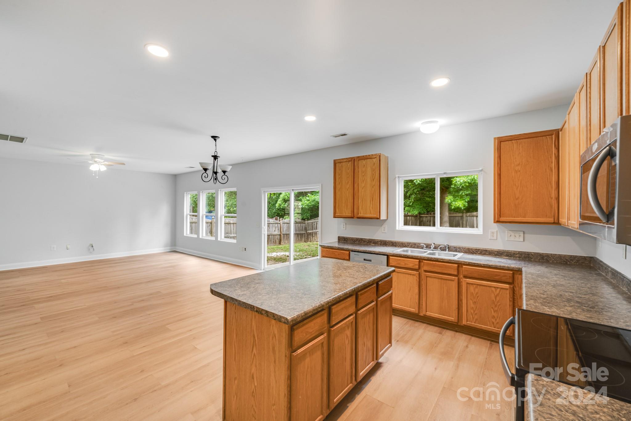 4420 Red Hook Road Monroe, NC 28110 - Photo 15 of 34 a kitchen with granite countertop a sink stove and wooden cabinets