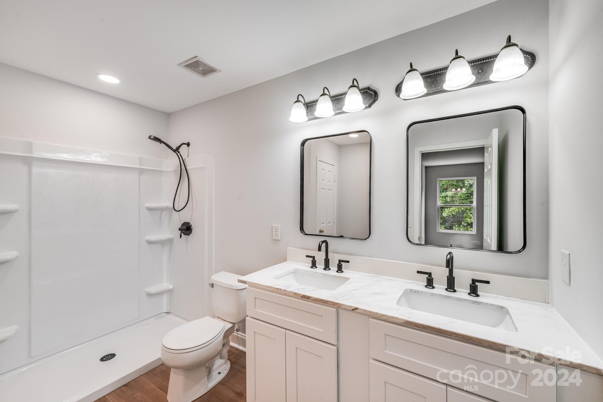 4420 Red Hook Road Monroe, NC 28110 - Photo 19 of 34 a bathroom with a double vanity sink mirror and toilet