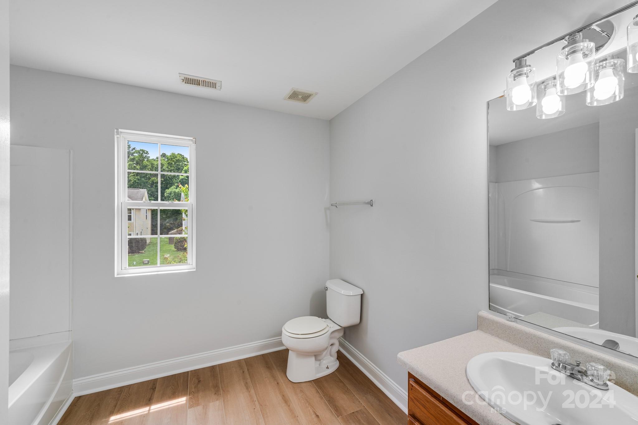4420 Red Hook Road Monroe, NC 28110 - Photo 28 of 34 a bathroom with a toilet a sink and a window