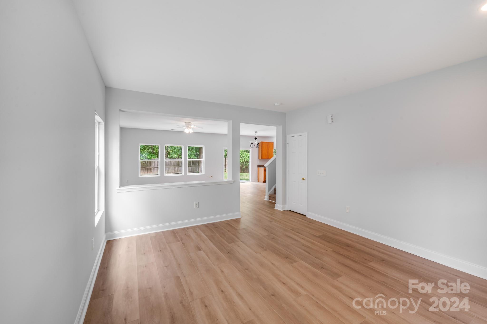 4420 Red Hook Road Monroe, NC 28110 - Photo 6 of 34 an empty room with wooden floor and windows