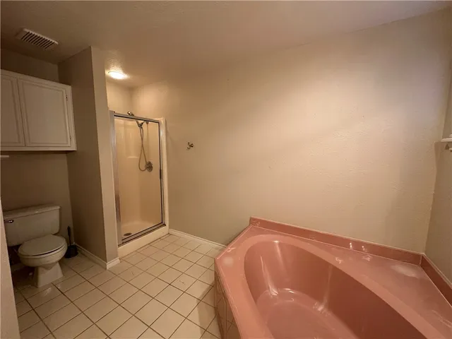 a bathroom with a tub and toilet