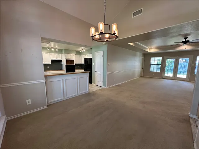 a view of a room with chandelier and windows
