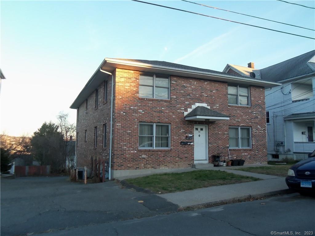 31 Chambers Street Waterbury, CT 06708 - Photo 1 of 1 a front view of a house with a garden