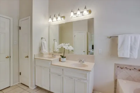 a bathroom with a sink vanity and a mirror