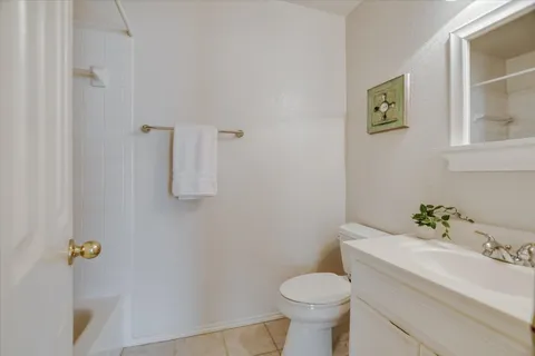a white toilet sitting next to a bathroom sink