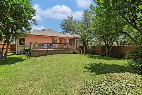 a view of a house with a yard and hanging chair