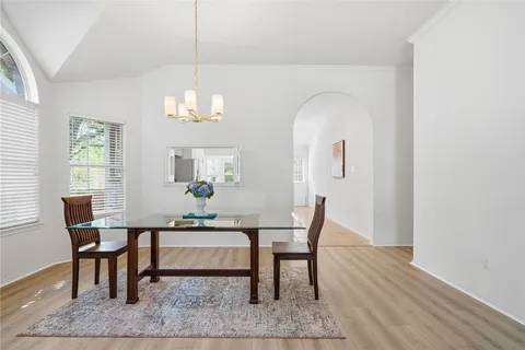 a workspace with wooden floor and a chandelier