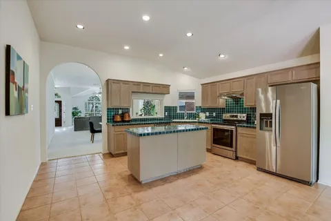 a kitchen with stainless steel appliances a refrigerator sink and stove