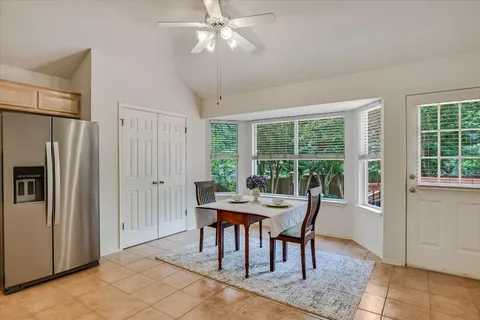 a dining room with furniture a chandelier and a rug