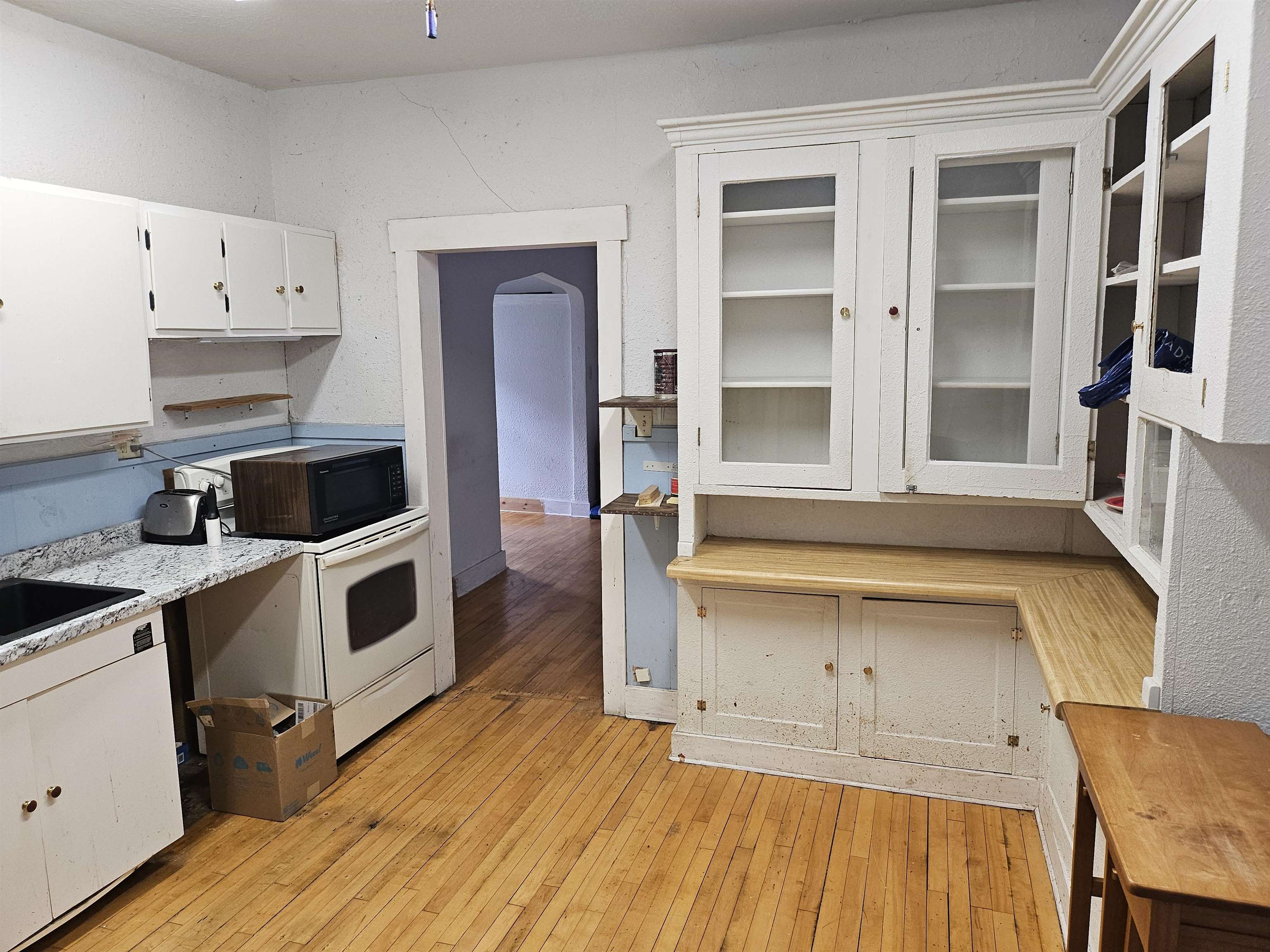 917 East 7th Street Duluth, MN 55805 - Photo 14 of 17 Kitchen with white cabinets, light wood-style floors, white electric stove, and glass insert cabinets