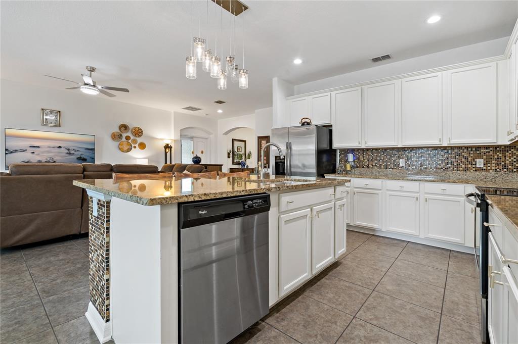 178 Magneta Loop Auburndale, FL 33823 - Photo 14 of 77 a kitchen with a sink stove and cabinets