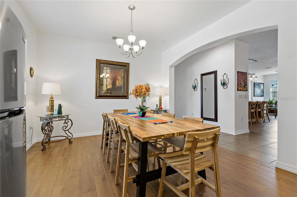 178 Magneta Loop Auburndale, FL 33823 - Photo 15 of 77 a view of a dining room with furniture wooden floor and chandelier