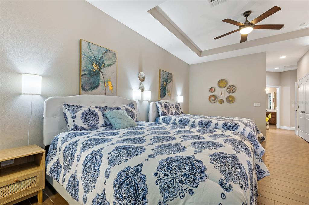 178 Magneta Loop Auburndale, FL 33823 - Photo 19 of 77 a bedroom with a large bed and a chandelier