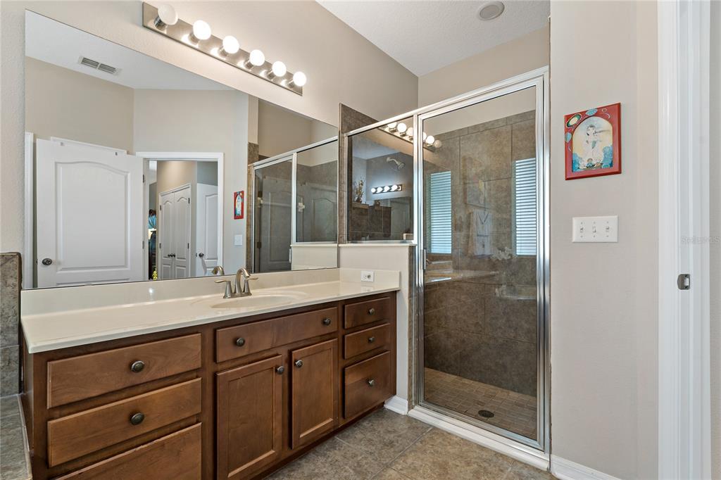 178 Magneta Loop Auburndale, FL 33823 - Photo 22 of 77 a bathroom with a shower sink and mirror
