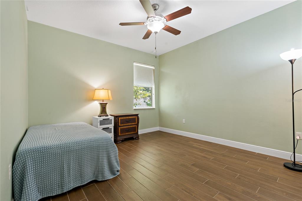 178 Magneta Loop Auburndale, FL 33823 - Photo 25 of 77 a bedroom with a bed and a chandelier