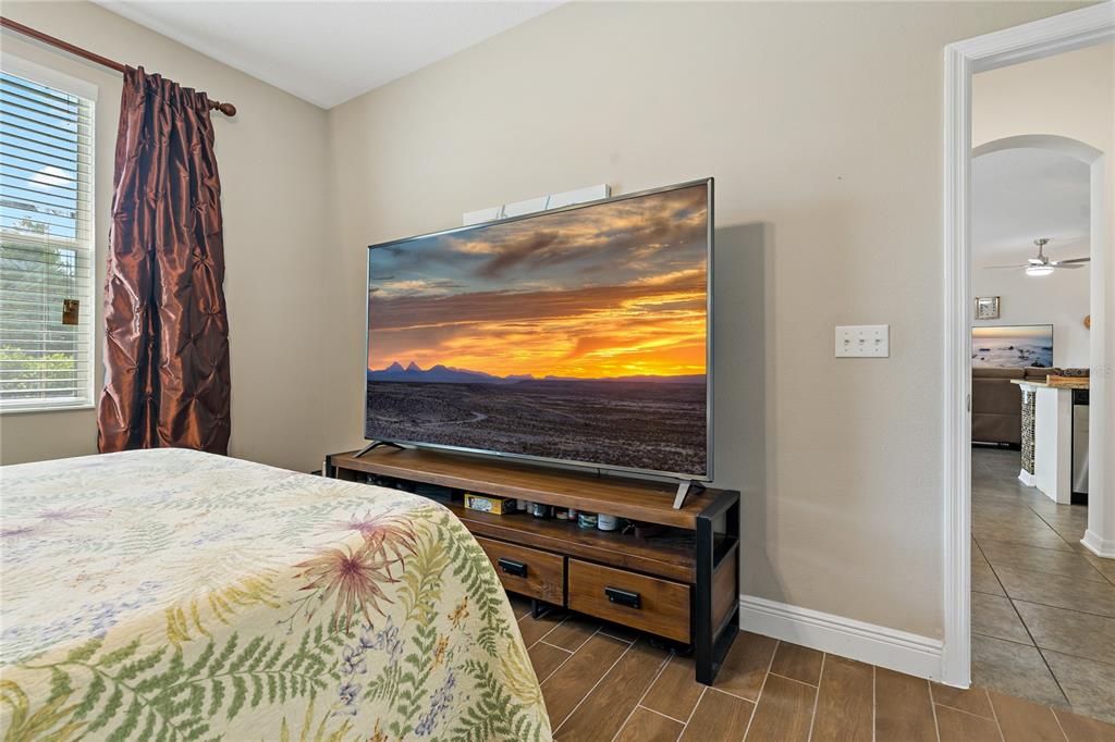 178 Magneta Loop Auburndale, FL 33823 - Photo 31 of 77 a bedroom with a bed and a flat screen tv