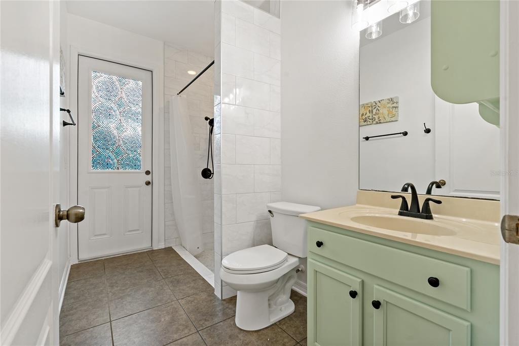 178 Magneta Loop Auburndale, FL 33823 - Photo 33 of 77 a bathroom with a toilet a sink and mirror