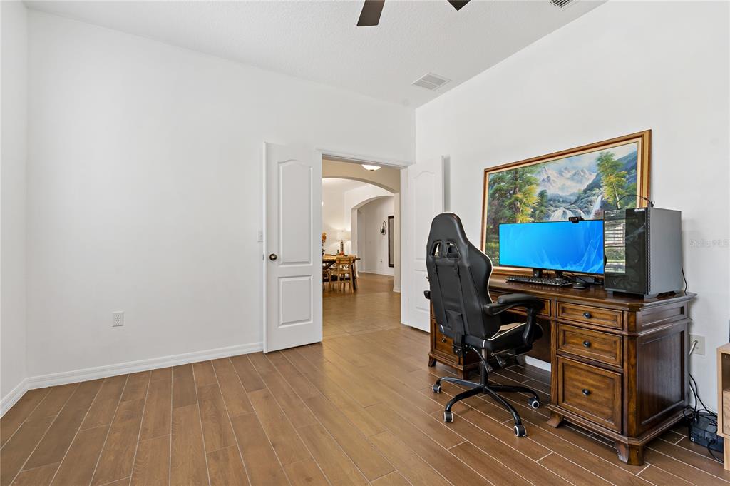 178 Magneta Loop Auburndale, FL 33823 - Photo 37 of 77 a room with wooden floor and gym equipment