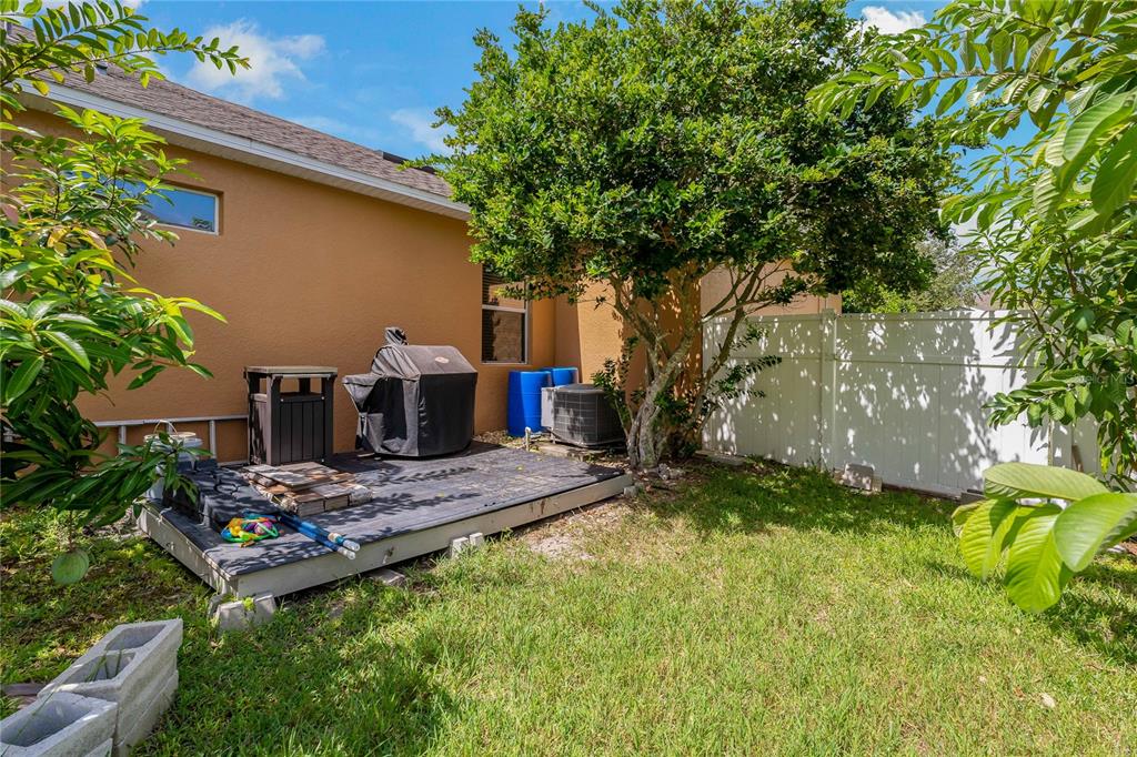 178 Magneta Loop Auburndale, FL 33823 - Photo 48 of 77 a backyard of a house with yard and outdoor seating