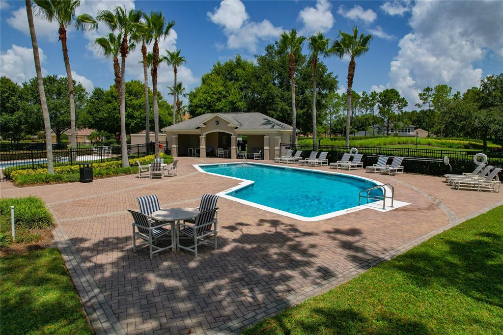 178 Magneta Loop Auburndale, FL 33823 - Photo 67 of 77 a view of a garden with a table chairs and a swimming pool