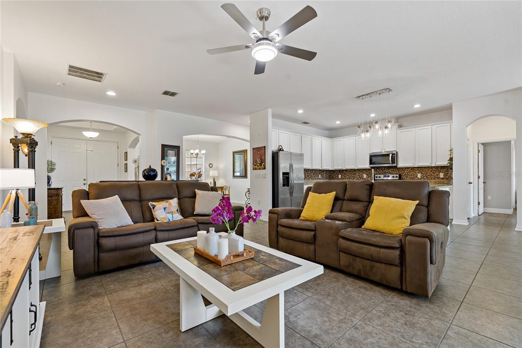 178 Magneta Loop Auburndale, FL 33823 - Photo 8 of 77 a living room with furniture kitchen view and a chandelier