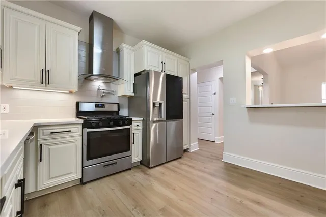 a kitchen with stainless steel appliances a refrigerator stove and microwave