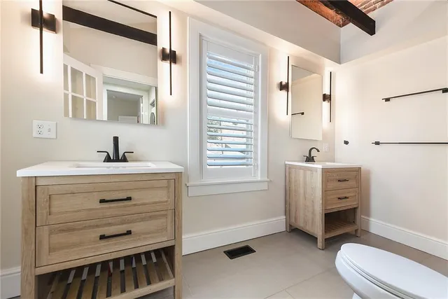 a bathroom with a sink a toilet a tub and mirror