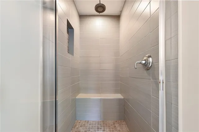 a spacious bedroom with a bed and wooden floor