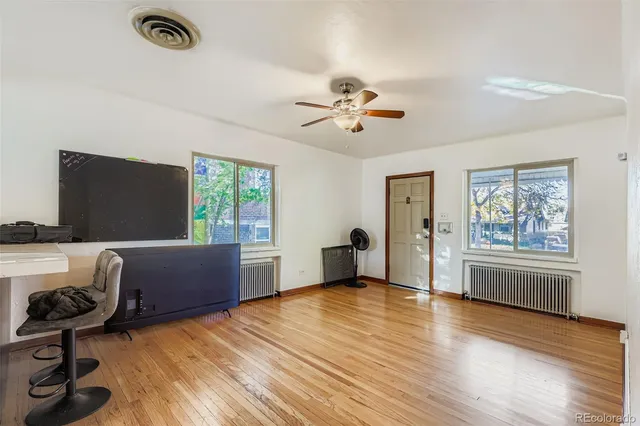a view of workspace with wooden floor and ceiling fan