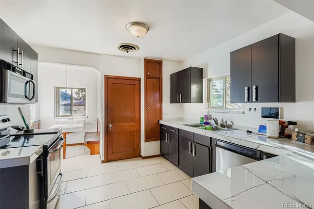 a kitchen with stainless steel appliances a sink stove and refrigerator