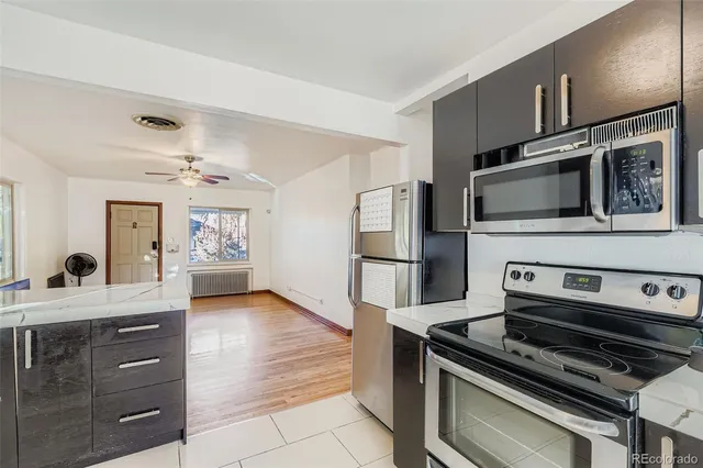 a kitchen with stainless steel appliances a stove microwave and cabinets