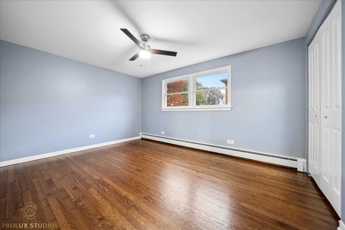 6935 West 64th Place, Unit 2A Chicago, IL 60638 - Photo 11 of 15 a view of an empty room with wooden floor and a window