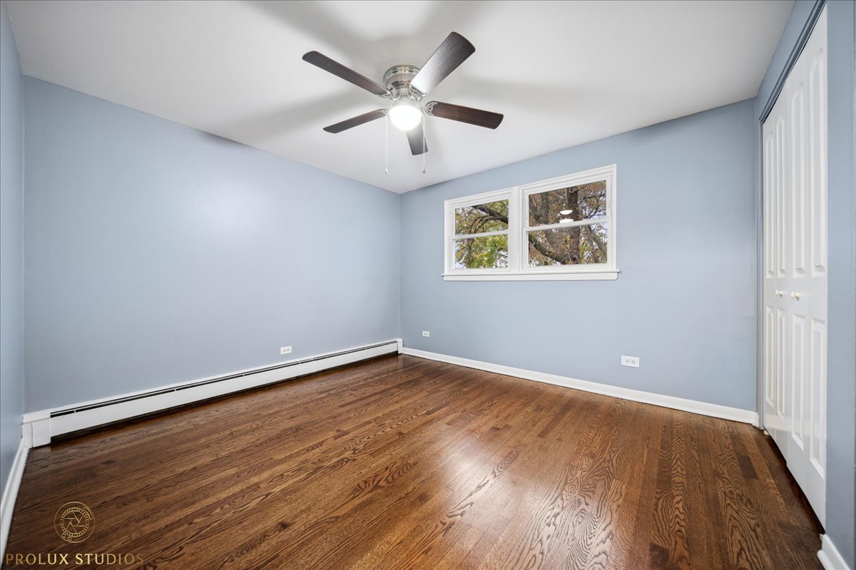 6935 West 64th Place, Unit 2A Chicago, IL 60638 - Photo 12 of 15 wooden floor in an empty room with a window