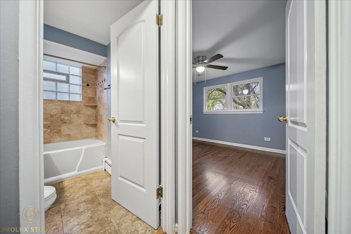 6935 West 64th Place, Unit 2A Chicago, IL 60638 - Photo 13 of 15 a view of an empty room with wooden floor and a window